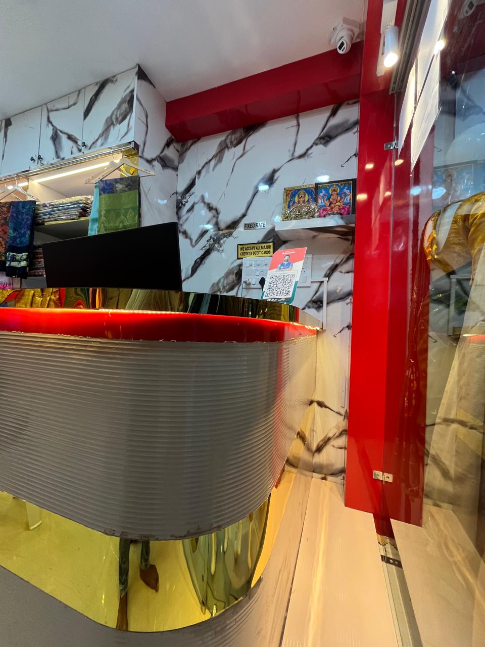 Curved billing counter with gold and red accents