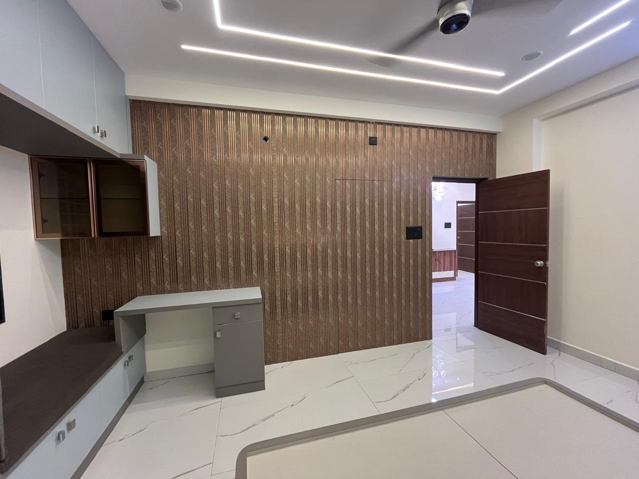 Bedroom entry with fluted feature wall and dresser