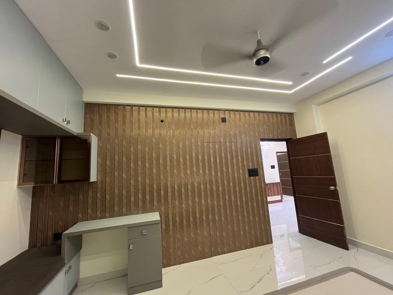 Bedroom with fluted wood paneling and study unit