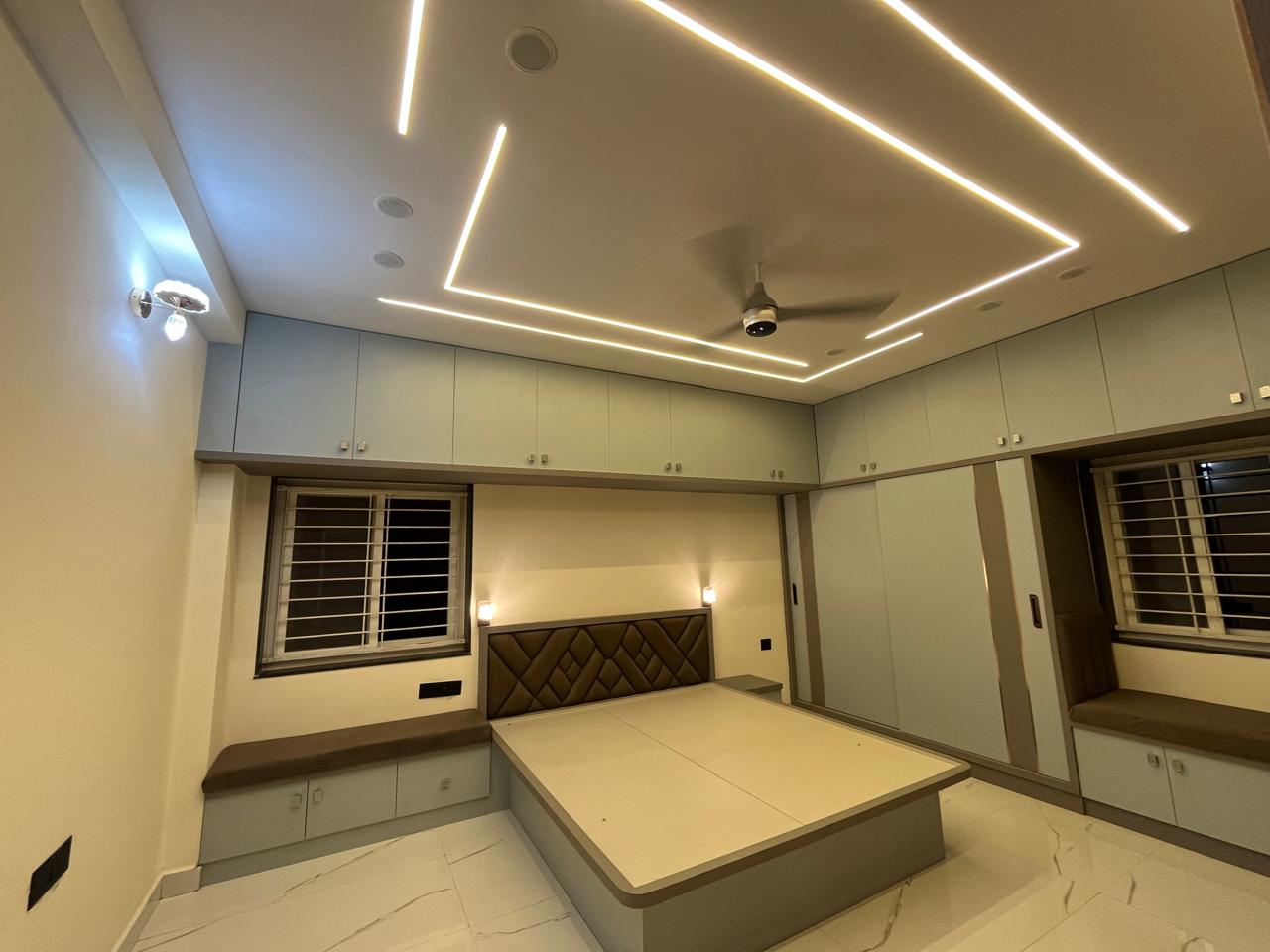 Master bedroom with cove-lit false ceiling and tufted headboard