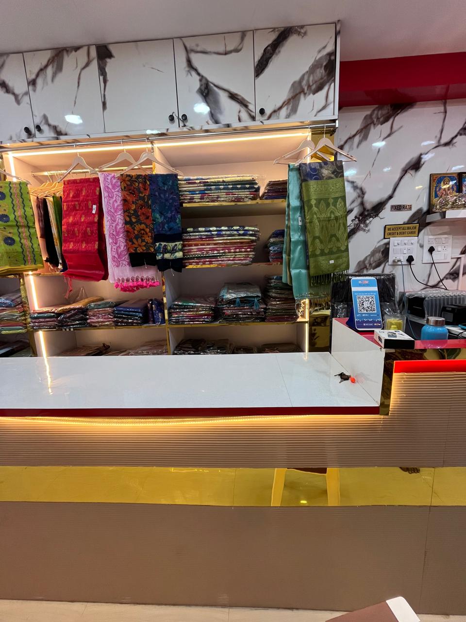 Saree display with billing counter and marble back wall